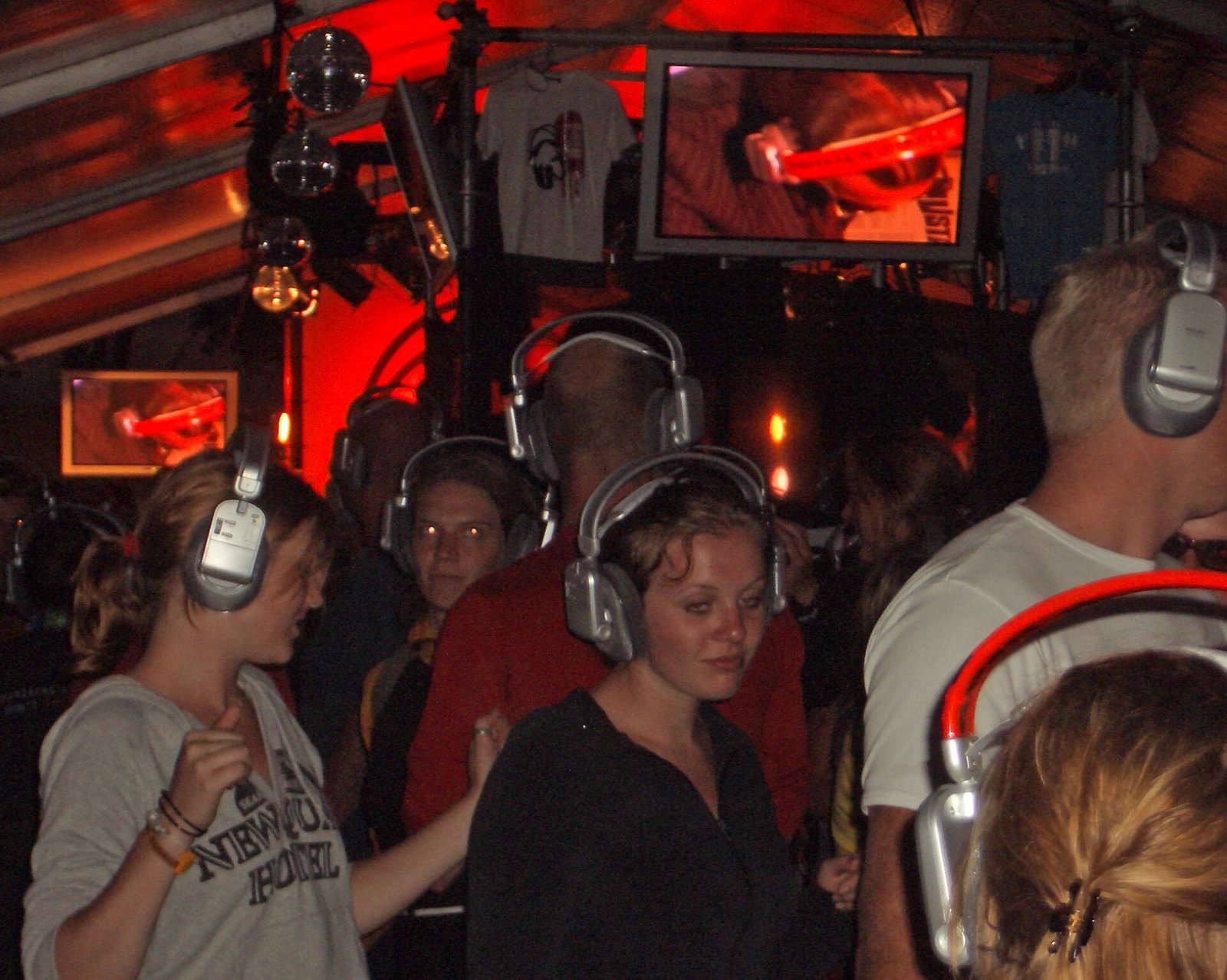 Crowd dancing in silver wireless headphones at a silent disco in the Netherlands, 2004